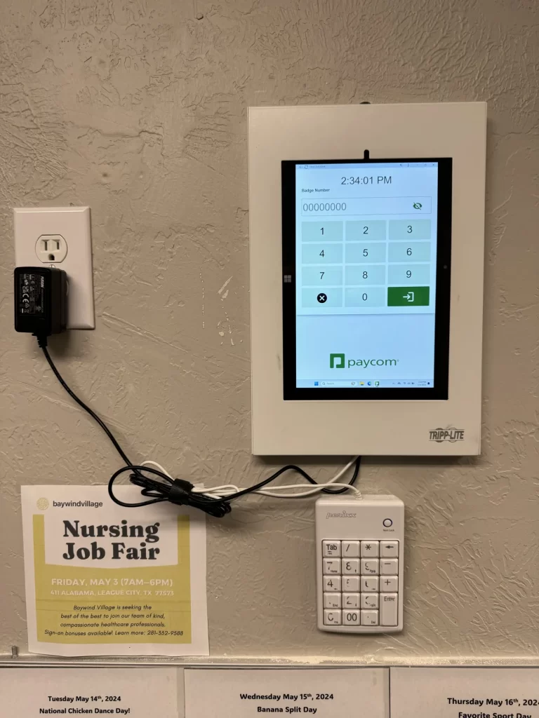 Wall-mounted Paycom time clock installed by SpaceCenter Systems at Baywind Village