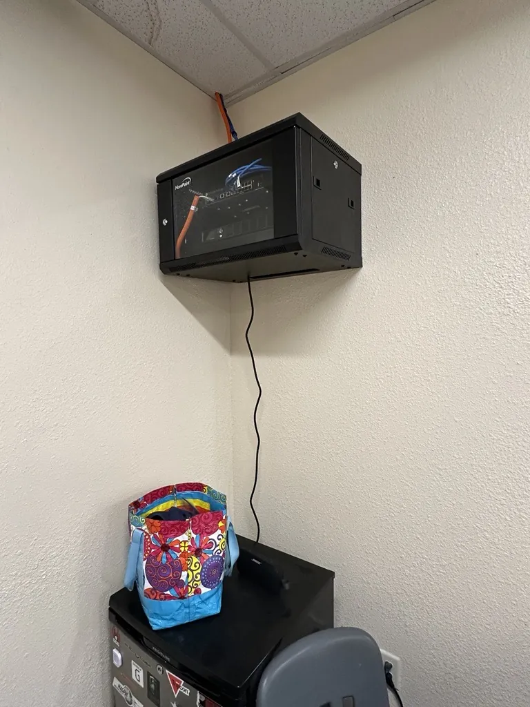 Wall-mounted network rack installed by SpaceCenter Systems at Horizon Montessori