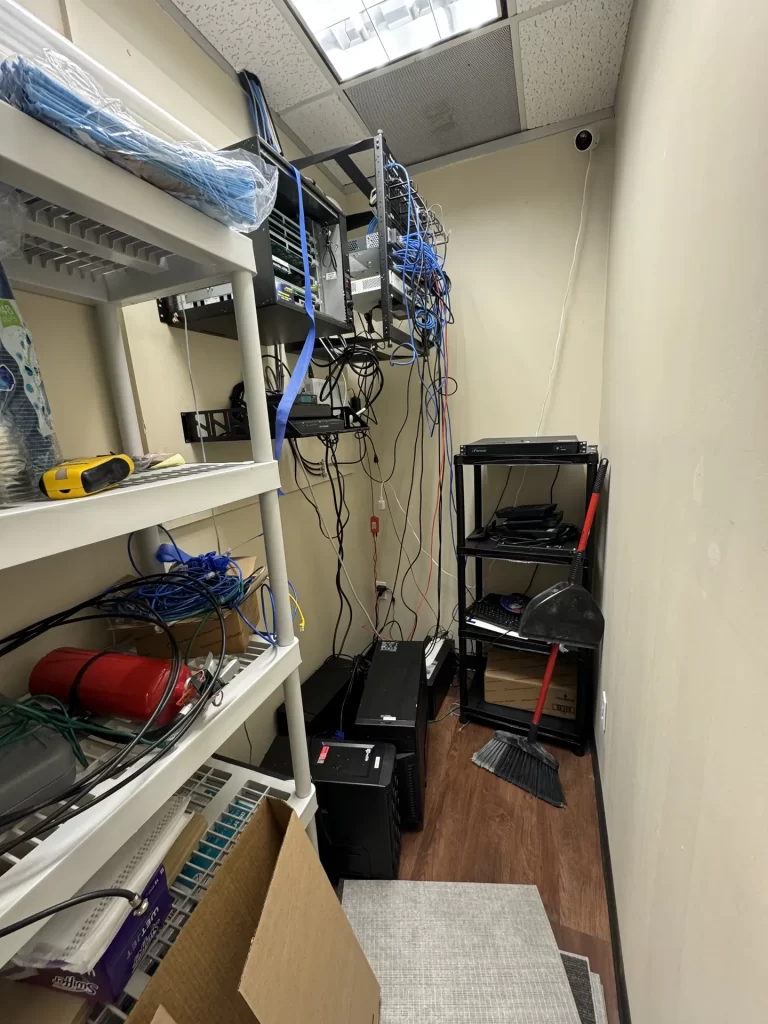 Cluttered network room with loose cabling before SpaceCenter Systems rework at Windy Hill